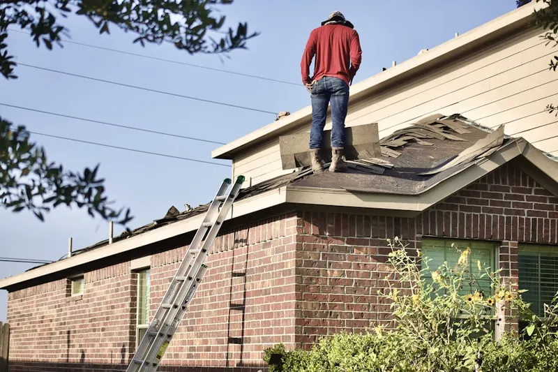 Professional roofer working on a residential roof in Frederick Junction